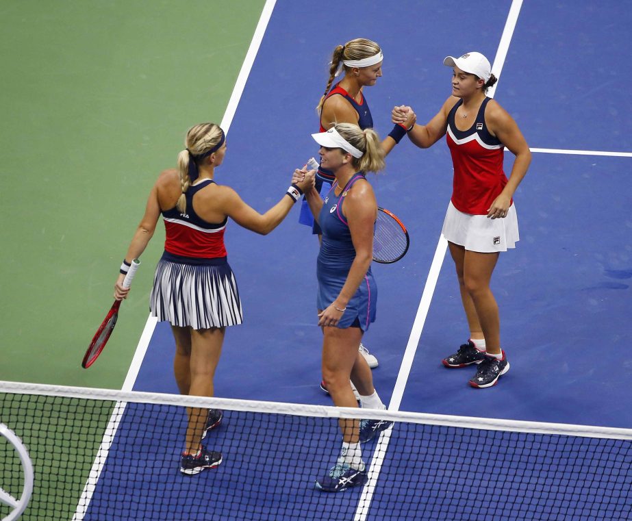 Timea Babos (bottom left) of Hungary, and Kristina Mladenovic (top left) of France, congratulate CoCo Vandeweghe (bottom right) and Ashleigh Barty of Australia, after Vandeweghe and Barty won the women's double final of the US Open tennis tournament on