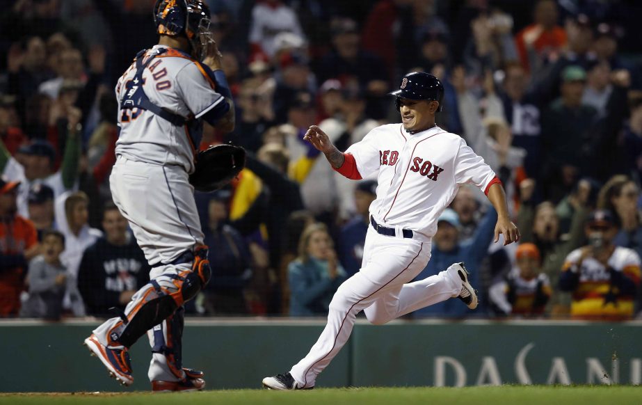 Boston Red Sox's Tzu-Wei Lin (right) scores the game-winning run in front of Houston Astros' Martin Maldonado on a single by Mitch Moreland during the ninth inning of a baseball game in Boston on Sunday.