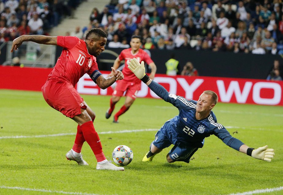Peru's Jefferson Frafan (left) misses a chance to score against German goalkeeper Marc Andree per Steven during a friendly soccer match between Germany and Peru in Sinsheim, Germany on Sunday.