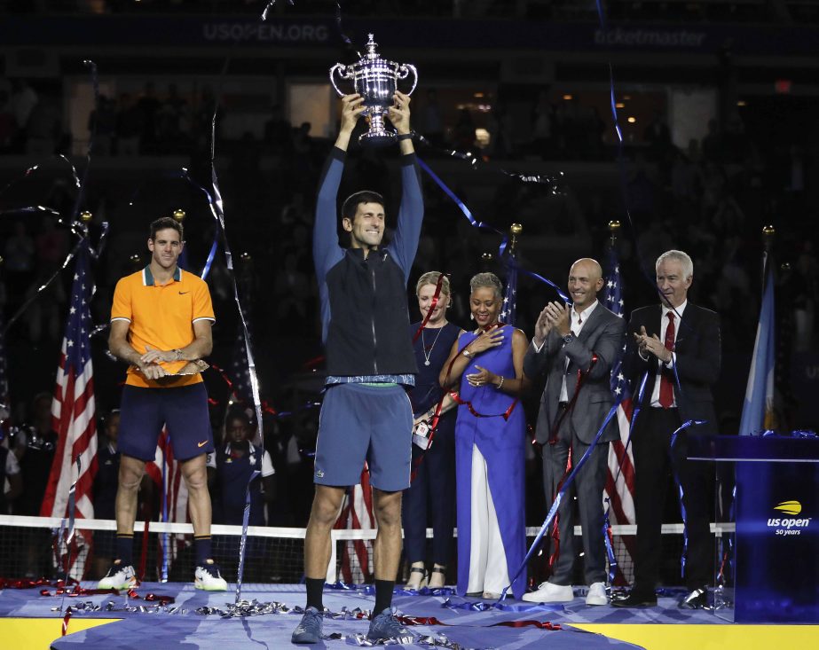 Novak Djokovic of Serbia, holds up the championship trophy after defeating Juan Martin del Potro of Argentina during the men's final of the U.S. Open tennis tournament in New York on Sunday.