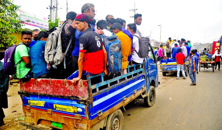People boarded the pick up vans to reach their destinations by taking risk of life as plying of Leguna service was banned recently. The photo was taken from Jatrabari Highway area on Monday.