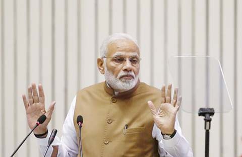 India's Prime Minister Narendra Modi gestures as he addresses the gathering during the 'Global Mobility Summit' in New Delhi.
