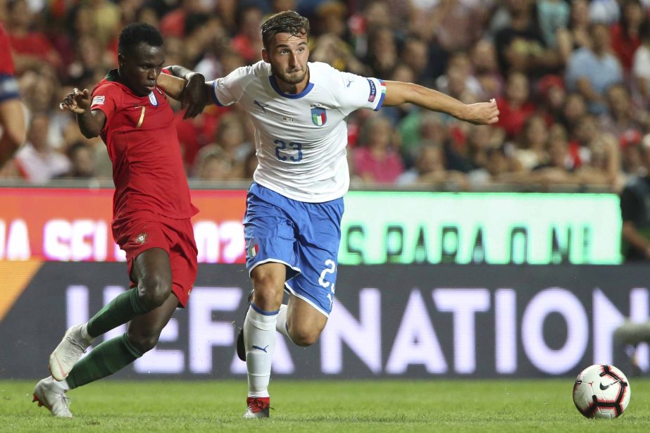 Italy's Brian Cristante, right, holds off Portugal's Bruma during the UEFA Nations League soccer match between Portugal and Italy at the Luz stadium in Lisbon on Monday.