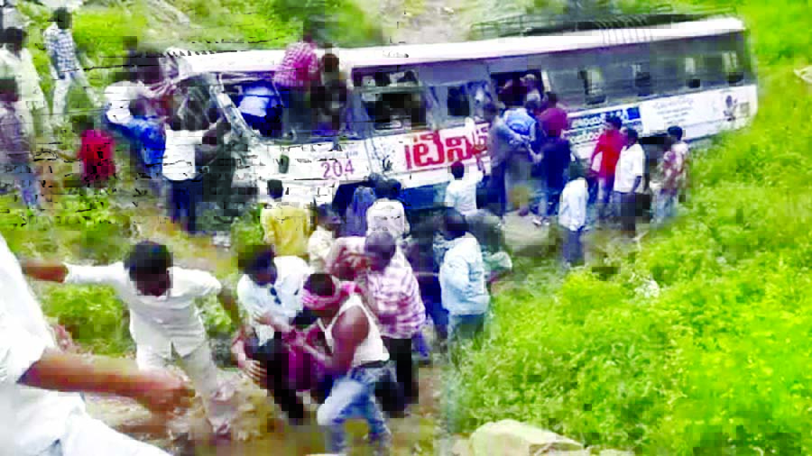 Rescuers pull out passengers from a bus that fell into a gorge in Jagtiyal district of Telangana, on September 11, 2018.