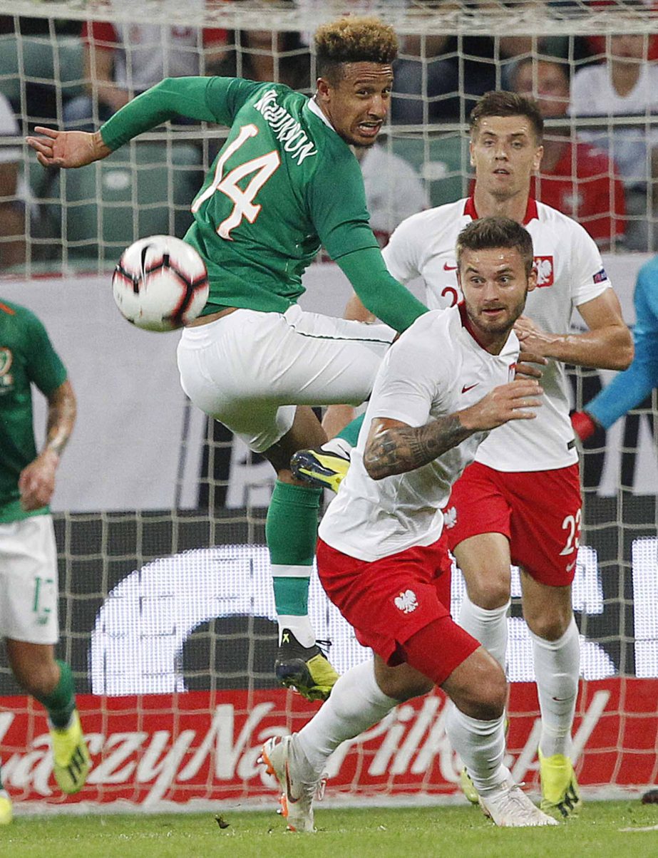 Poland's Karol Linetty (right) is challenged by Ireland's Callum Robinson (left) during friendly soccer match between Poland and Ireland at stadium in Wroclaw, Poland on Tuesday.