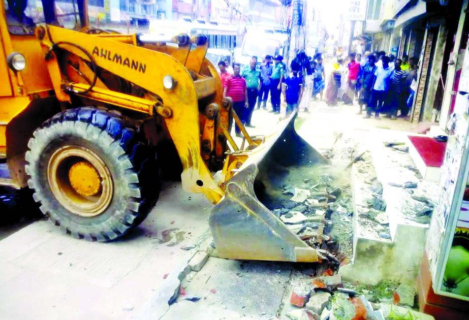 Rajuk authorities evicted illegal structures by the side of the road at Kazipara area at Mirpur on Wednesday.