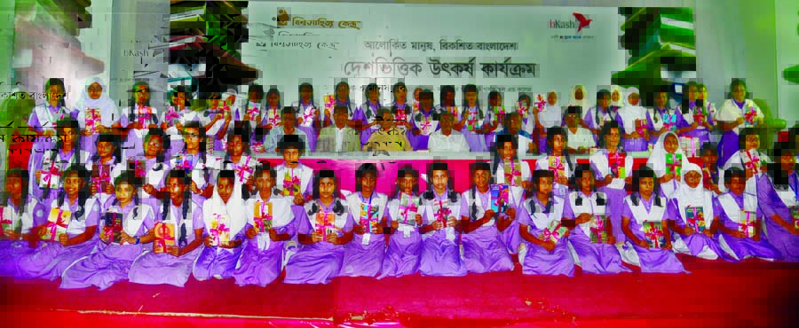 Founder President of the Bishwa Sahitya Kendra (BSK) Prof Abdullah Abu Sayeed among the students at the book distribution ceremony under 'Book Reading Programme' organised by BSK in the auditorium of Azimpur Government Girls' School and College in the
