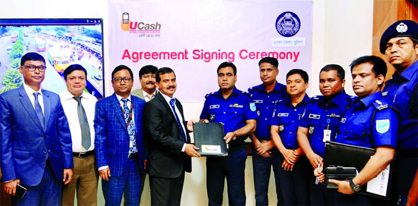 Sha Migan Shafiur Rahman, Police Super of Dhaka District and ATM Tahmiduzzaman, Head of UCash (mobile financial services) of United Commercial Bank Limited, exchanging an agreement signing documents on traffic case payment through UCash at the Bank head o
