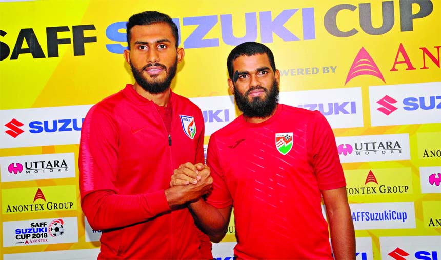 Captain of Indian Football team and Captain of Maldives Football team shaking hands at the conference room in Bangladesh Football Federation House on Friday.