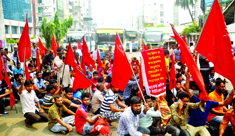 Under the banner of Garment Workers' Trade Union center, RMG workers staged sit-in demo in front of the Jatiya Press Club, rejecting fixation of minimum wage at Tk 8000. The photo was taken on Friday.