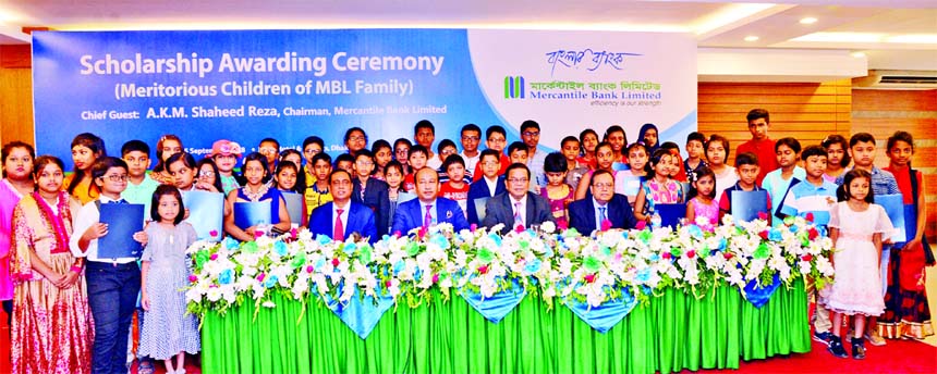 Mercantile Bank Limited, awarded scholarships to the meritorious children of the Bank's families. AKM Shaheed Reza, Chairman of the Bank, poses for a photo session with the scholarship recipient students at a hotel in the city on Saturday. Akram Hossain