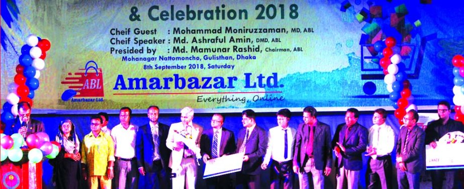 Mamunur Rashid, Chairman of Amarbazar Limited (an online marketplace in Bangladesh), handing over a gift to the official of the company during its Eid reunion, product demonstration and celebration at Mohanagar Nattya Manncha in the city recently. Mohamma
