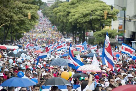 Thousands of persons march to demand that Costa Rican President Carlos Alvarado scrap a proposed fiscal reform before congress that includes new taxes, in the streets of San Jose, Costa Rica.