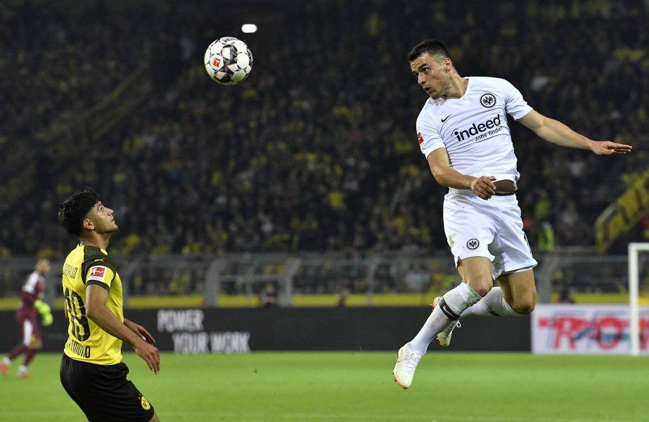 Frankfurt's Filip Kostic (right) and Dortmund's Mahmoud Dahoud (left) challenge for the ball during the German Bundesliga soccer match between Borussia Dortmund and Eintracht Frankfurt in Dortmund, Germany on Friday.