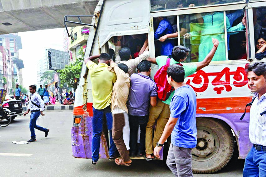 Despite students' safe road movement, some people seen trying to board a running bus risking their own lives at Shantinagar area on Saturday.