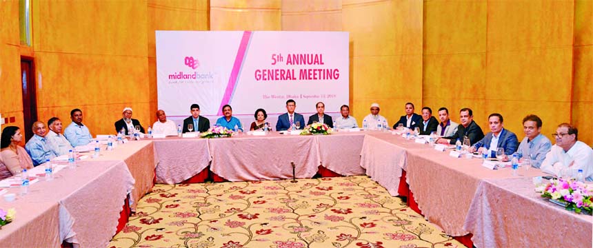 Nilufer Zafarullah, MP, Vice Chairman of the Board of Directors of Midland Bank Limited presiding over its 5th Annual General Meeting at a city auditorium recently. Md. Ahsan-uz Zaman, Managing Director and Mohammad Masoom, AMD of the Bank were also pres