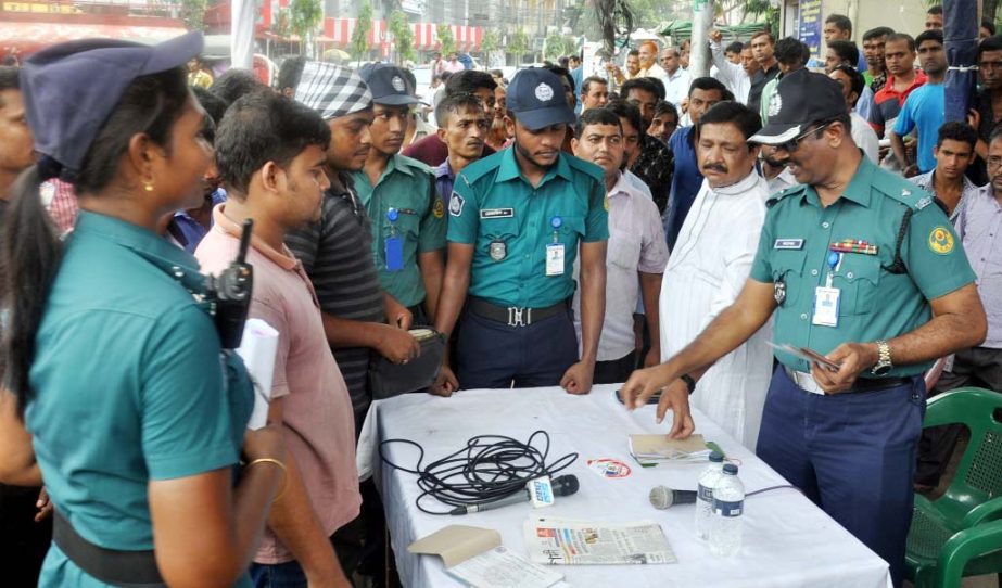 Police examining fitness certificates of vehicles at Agrabad area in the Port City on Saturday.