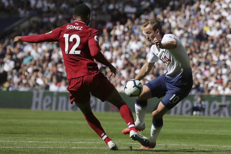 Tottenham's Harry Kane (right) challenges for the ball with Liverpool's Joe Gomez during the English Premier League soccer match between Tottenham Hotspur and Liverpool at Wembley Stadium in London on Saturday.