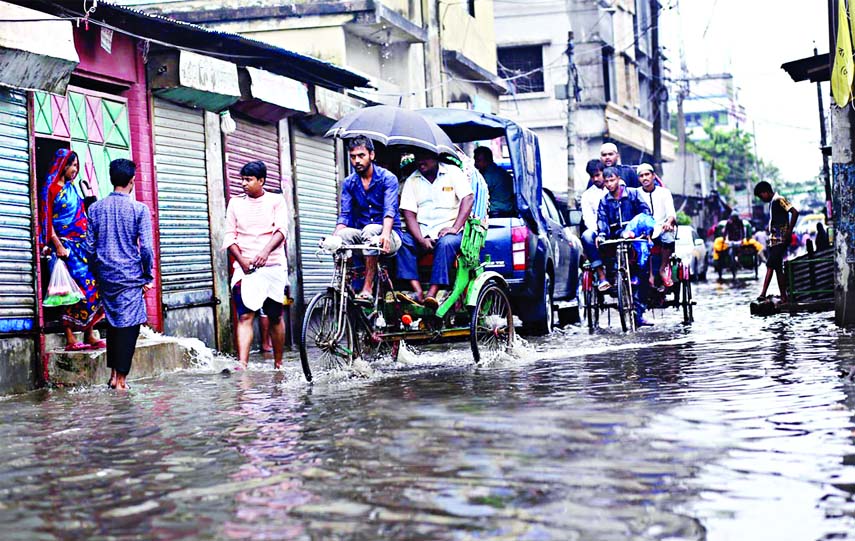 In absence of adequate drainage system, a street of city's Kazla (graveyard road) area was inundated by dirty water causing sufferings to the local people. This picture was taken on Sunday.