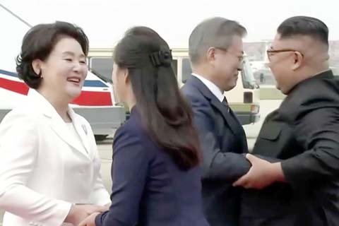 North Korean leader Kim Jong Un and his wife Ri Sol Ju greet South Korean President Moon Jae-in and First Lady Kim Jung-sook at Pyongyang Sunan International Airport, North Korea ahead of the third summit with North Korean leader Kim Jong Un in this still