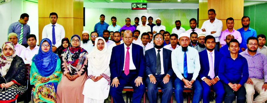 Md. Habibur Rahman, Managing Director of Al-Arafah Islami Bank Limited, poses for a photo session with the participants of a day-long training workshop on 'Islamic Banking' at the Bank's Training & Research Institute in the city on Monday. Md. Abdur Ra