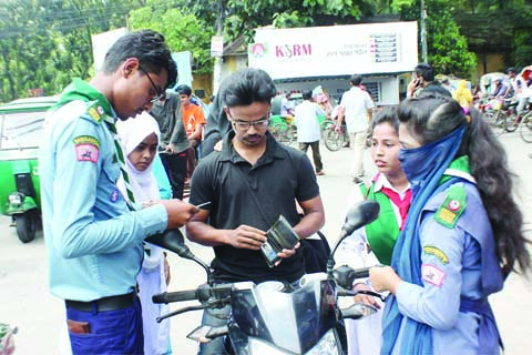 SYLHET: Members of scout checking fitness certificates of vehicles at Chouhatta area in Sylhet City marking the Traffic Campaign on Monday.
