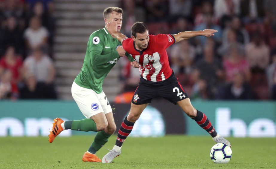 Brighton & Hove Albion's Solly March (left) puts pressure on Southampton's Cedric Soares during their English Premier League soccer match at St Mary's in Southampton, England on Monday.