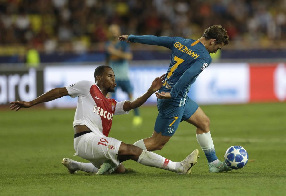 Monaco defender Djibril Sidibemo (left) battles with Atletico forward Antoine Griezmann during the Champions League Group A soccer match between Monaco and Atletico Madrid at the Louis II stadium in Monaco on Tuesday.