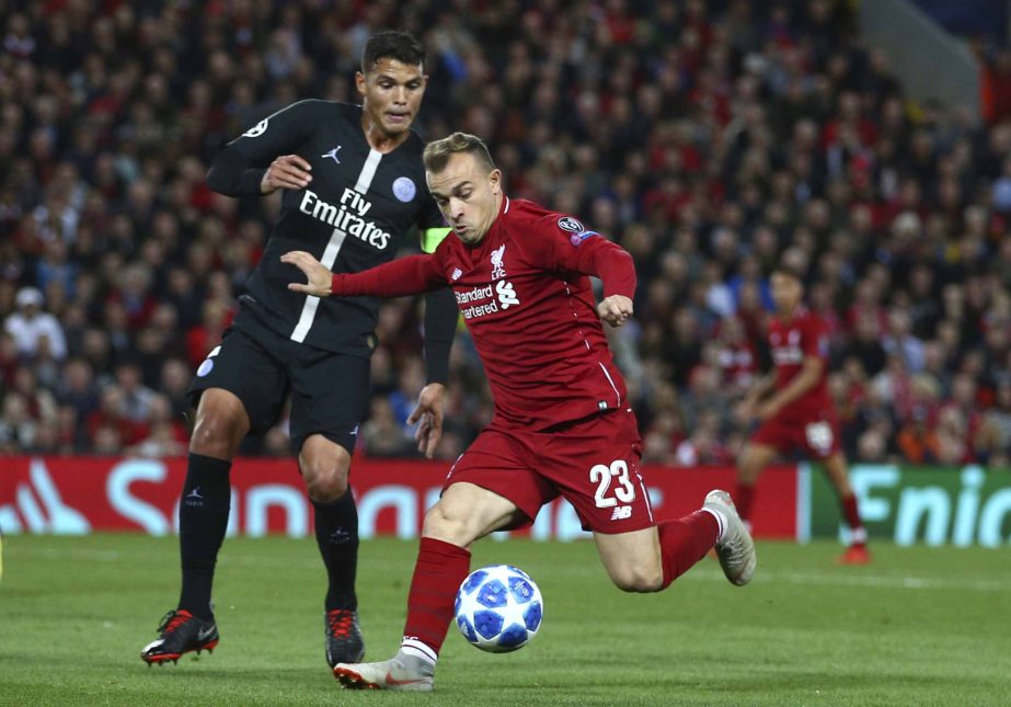 Liverpool's Xherdan Shaqiri (right) vies for the ball with PSG's Thiago Silva during the Champions League Group C soccer match between Liverpool and Paris-Saint-Germain at Anfield stadium in Liverpool, England on Tuesday.