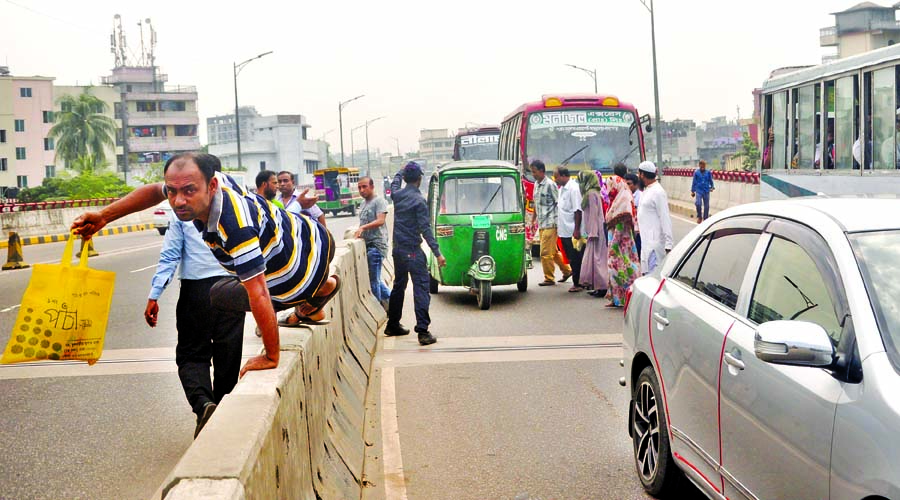 Despite ban on movement over flyovers, pedestrians are seen passing through Hanif Flyover risking their lives. The photo was taken from Jatrabari area on Wednesday.