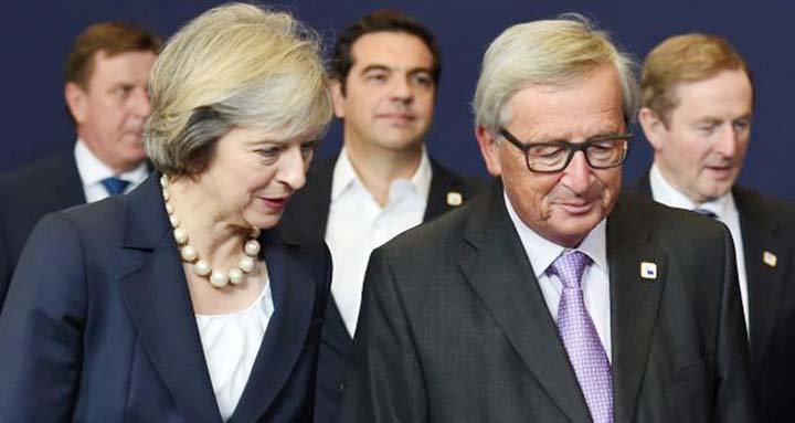 British prime minister Theresa May talks with European Commission president Jean-Claude Juncker at the European Union leaders summit in Brussels also attended by Taoiseach Enda Kenny, seen on the right.
