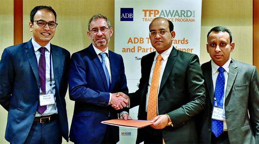 Steven Beck, Head of Trade and Supply Chain Finance of ADB and Md. Obaidul Islam, Executive Vice President and Head of Financial Institutions and Offshore Banking of Eastern Bank Ltd, exchanging documents after signing a Trade Facilitation deal in Singap