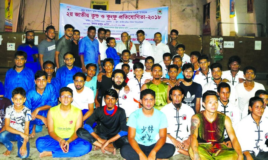 The winners of the 2nd National Kushu and Kung-Fu Competition with the chief guest Secretary of National Sports Council Md Masud Karim and the officials and guests of Bangladesh Martial Art Confederation pose for a photo session at the Gymnasium of Nation