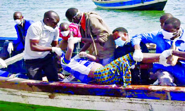 Rescuers retrieve a body from the water near Ukara Island in Lake Victoria, Tanzania on Friday.