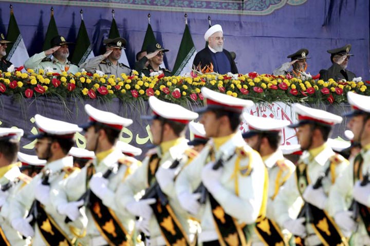Iran's President Hassan Rouhani, top center, reviews army troops marching during the 38th anniversary of Iraq's 1980 invasion of Iran, in front of the shrine of the late revolutionary founder, Ayatollah Khomeini, outside Tehran on Saturday.