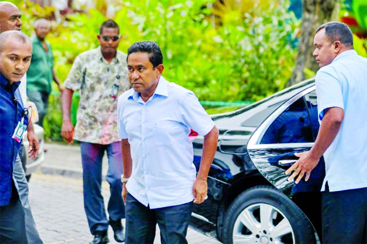 Maldives President Abdulla Yameen arrives at a polling station to vote in a controversial election that foreign observers have claimed is rigged in the strongman's favour.