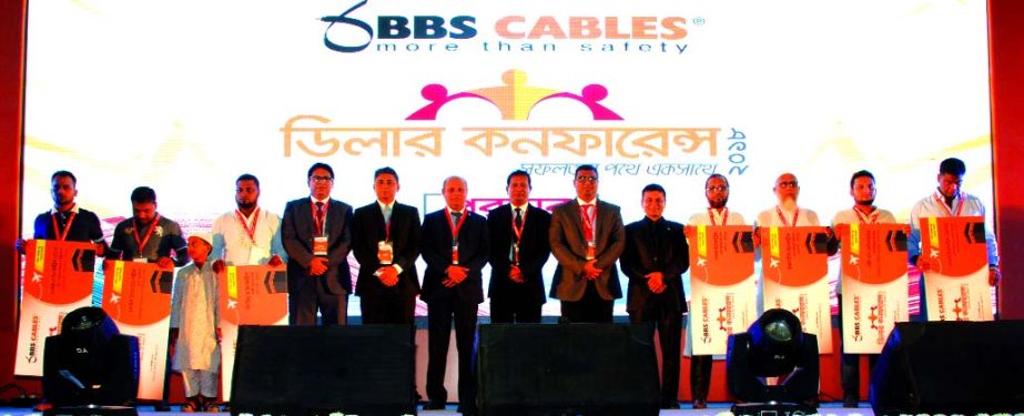 Engr. Mohammad Badrul Hasan, Chairman along with Engr. Abu Noman Howlader, Managing Director of BBS Cables Limited, poses for a photo session with the participants at its 'Dealersâ€™ Conference-2018' at a convention centre in the city on Sunday. En