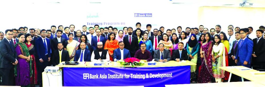 Mohammad Borhanuddin, Managing Director (CC) of Bank Asia Limited, poses for a photo session with the participants of a day-long training on 'Islamic Banking & Finance' organized by the Institute for Training & Development of the Bank at its head office