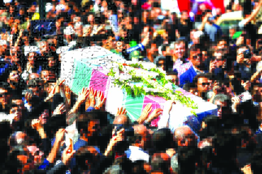 Iranians carry a coffin during a public funeral ceremony on Monday for people killed during a weekend attack on a military parade in the southwestern Iranian city of Ahvaz.