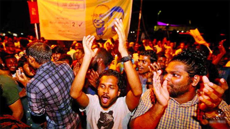 Supporters of Maldivian joint-opposition presidential candidate Ibrahim Mohamed Solih celebrate on the street at the end of the presidential election day in Male on Monday.