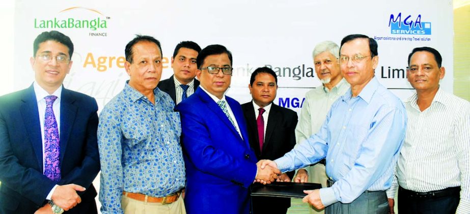 Khurshed Alam, Head of Retail Finance of LankaBangla Finance Limited (LBFL) and Group Captain Mohammed Salimullah (Rtd), Managing Partner of Meet Greet and Assist Services (MGA Services) exchanging a MoU signing document at LBFL office in the city recentl