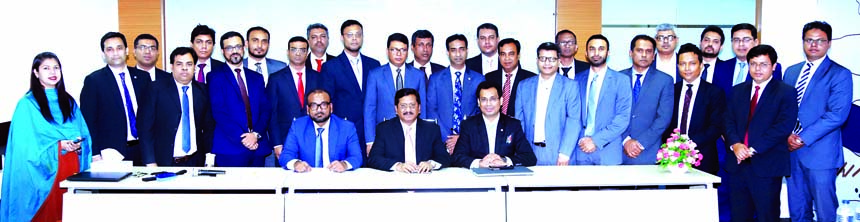 Md. Mehmood Husain, Managing Director of NRB Bank Limited, poses for a photo session with the participants of a two-day long executive development workshop on 'Fintech & Future Landscape of the Banking Industry in Bangladesh' at the Banks head office in