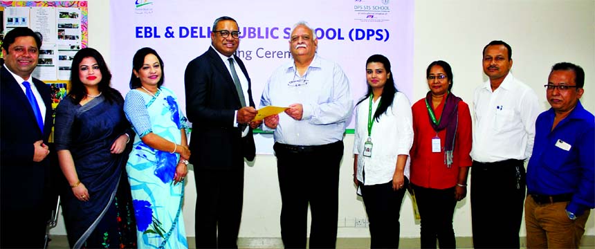 M. Khorshed Anowar, Head of Retail Banking of Eastern Bank Ltd and Harsh Wal, Principal, DPS STS School, Dhaka, exchanging documents after signing an agreement in the city recently . As a result students of the school will be able to make their canteen