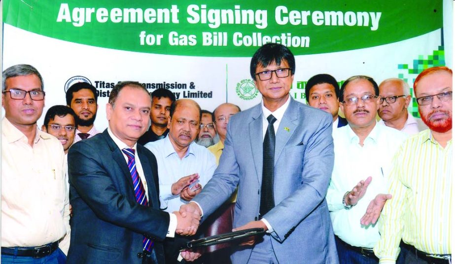 Abu Habib Khairul Kabir, General Manager of General Services and Development Division of Pubali Bank Limited and Md. Abdul Hakim Mukta, Company Secretary of Titas Gas Transmission and Distribution Company Limited (TGTDC), exchanging an agreement signing d