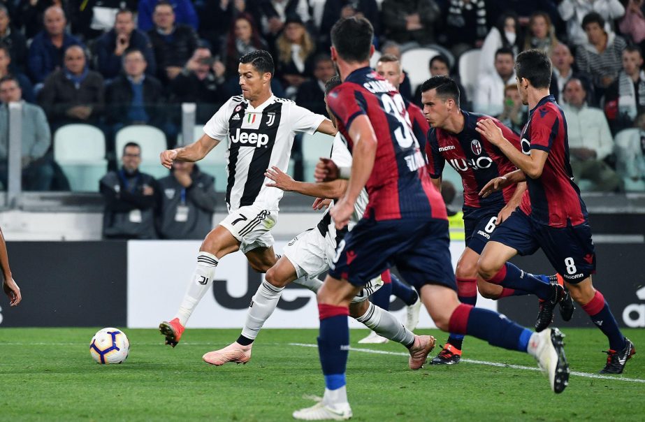 Juventus' Cristiano Ronaldo (left) goes for the ball during a Serie A soccer match between Juventus and Bologna at the Allianz Stadium in Turin, Italy on Wednesday.