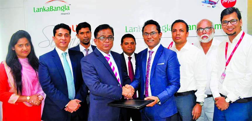 Khurshed Alam, Head of Retail Finance of LankaBangla Finance Limited (LBFL) and Morshedul Alam Chaklader, CEO of Total Air Services Limited (GSA Air Asia), exchanging a MoU signing document at LBFL head office in the city recently. Under the deal, LBFL ca