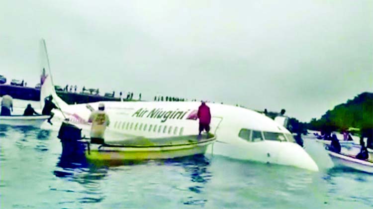 A view of the crashed Air Niugini plane with people rescuing passengers in Weno, Chuuk, Micronesia on Friday in this still image obtained from social media.