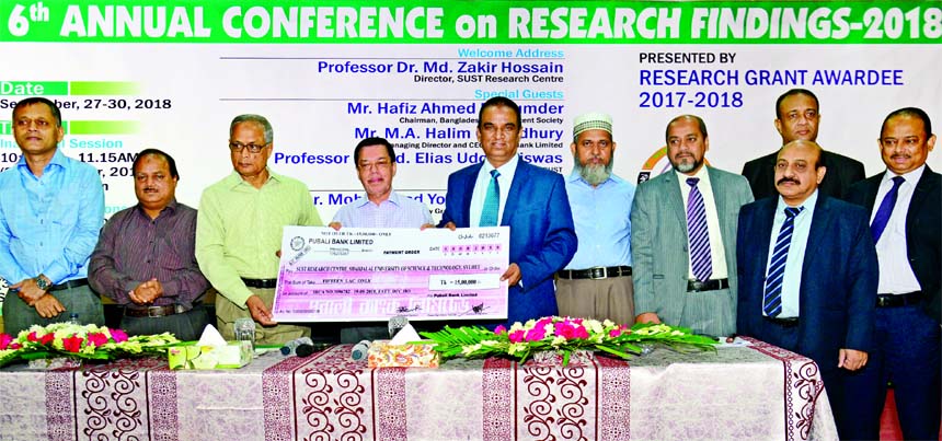 Md. Abdul Halim Chowdhury, Managing Director of Pubali Bank Ltd, handing over a cheque of Tk 15 lakh to Professor Farid Uddin Ahmed, Vice Chancellor of Shahjalal University of Science and Technology (SUST) Research Centre as a part of Corporate Social Re