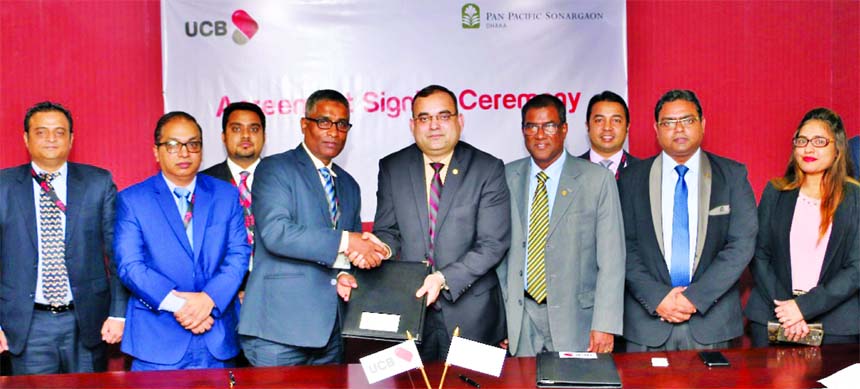 Taufiq Hassan, Head of Retail Business of United Commercial Bank Limited and Asif Ahmed, Director of Finance of Pan Pacific Sonargaon Hotel, exchanging an agreement signing document at the Bank's head office in the city recently. Under the deal, Platinum