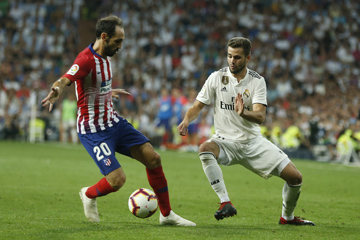 Real Madrid's Nacho Fernanzez (right) vies for the ball with Atletico Madrid's Juanfran during a Spanish La Liga soccer match between Real Madrid and Atletico Madrid at the Santiago Bernabeu stadium in Madrid, Spain on Saturday. The match ended in a 0-0